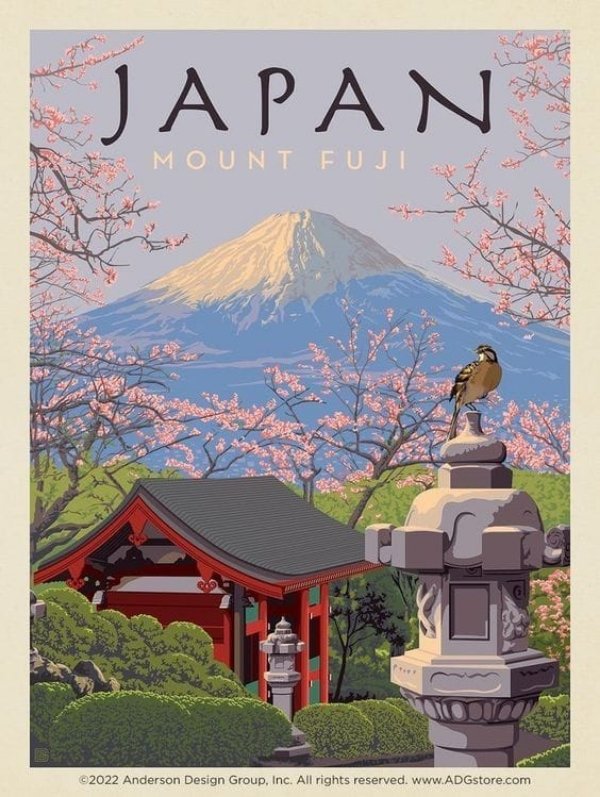 Japan Mount Fuji poster displayed above a modern desk with a laptop, lamp, plants, and books