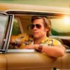 Vintage-style poster featuring a man wearing sunglasses sitting in a classic car with “Once Upon a Time in Hollywood” text.
